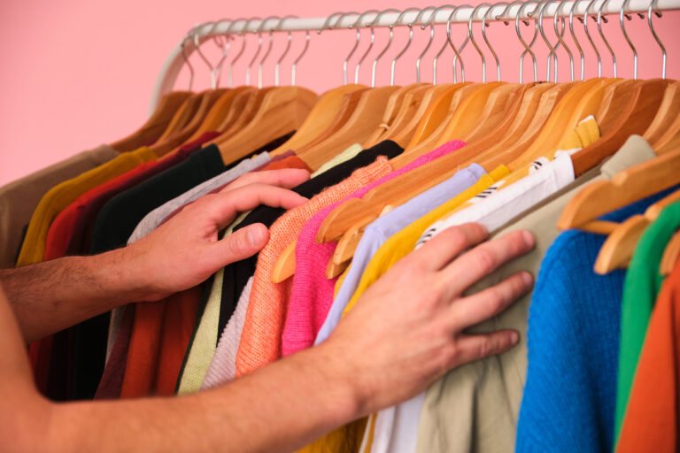 A person is looking through a rack of clothes, concept of election.